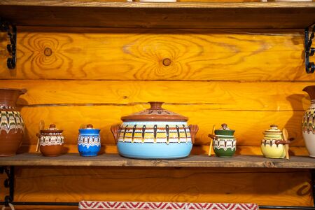 Old fashioned kitchen utensils in Russian folk style on wooden background