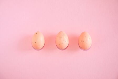 Pink easter eggs on pink background with text copy spaceの写真素材