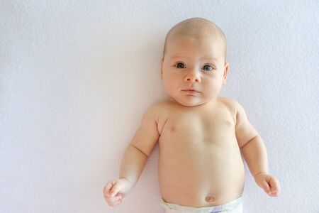 Close-up portrait of a beautiful baby girl on white background with text space