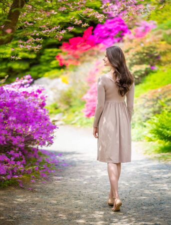 Young beautiful woman on a walk in the park of Pruhonice in Czech republicの写真素材
