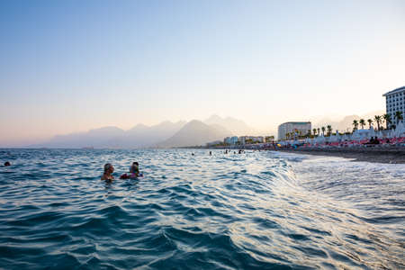 Antalya, Turkey - 2.09.2020: Konyaalti sand beach and Taurus mountains in sunset light, Antalya, Turkey Mediterranean coastのeditorial素材