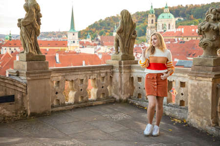 Young woman on red roof background in old town of Prague in Czech republic