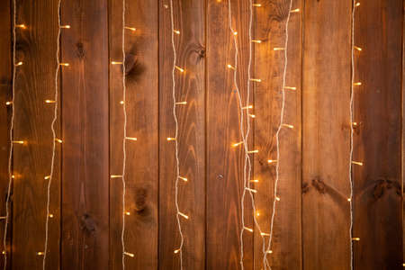 Christmas lights garland on a old antique wooden background