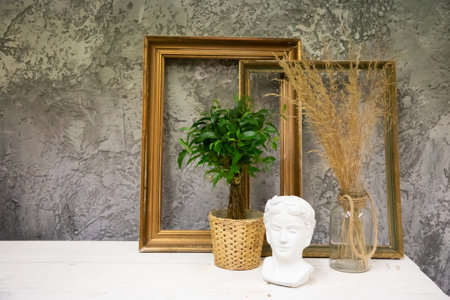 Sculpture bust and frames on table in the creative workshopの写真素材