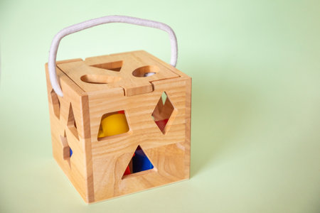 Cute wooden handmade toys for kids on green background. Ecological toys conceptの写真素材