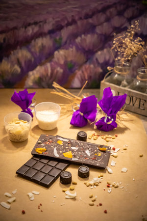Handmade chocolate with fresh and dried fruits on light paper background in rustic styleの写真素材