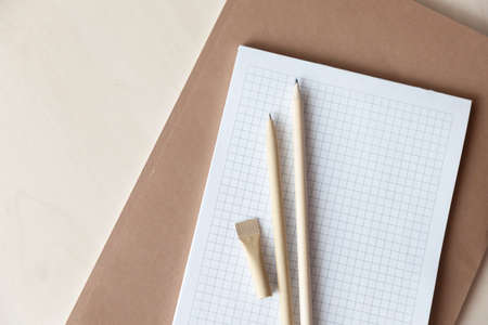 Reusable eco-friendly craft paper pen and pencil on the notebook. Writing ballpoint pen,...