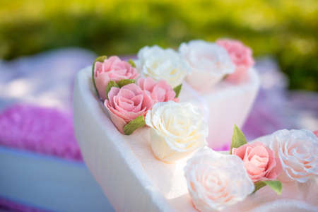 Cute handmade decoration for birthday party. Big paper number five with flowers in the park.の写真素材