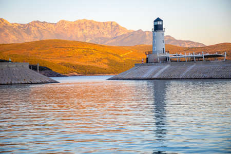 Lustica Bay, Montenegro - October 1, 2021: Lighthouse with restaurant at Lustica Bay in Montenegro at sunset lightsのeditorial素材