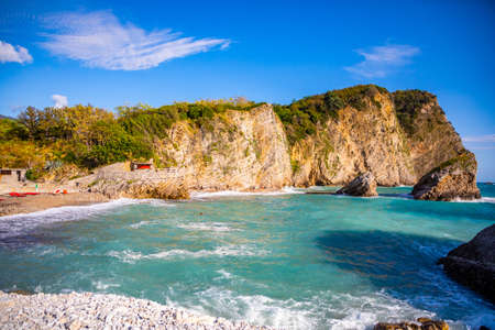 The beach and the cliffs on the island of St. Nicholas in Budva, Montenegro. Paradise beach on an island in the seaの写真素材