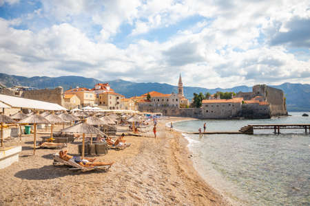 Budva, Montenegro - September 18, 2021: Beach of old town Budva. Ancient walls and tiled roof of old town Budva, Montenegroのeditorial素材
