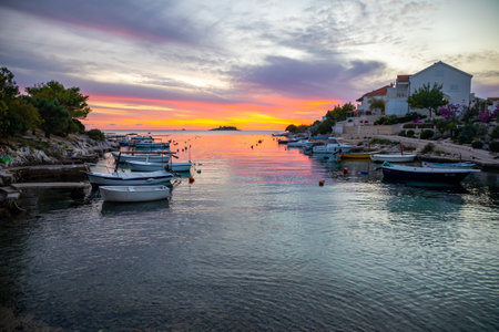 Rogoznica, Croatia - October 12, 2021: Beautiful area Lozica of Rogoznica town with sandy beach, white architecture and fishing boats at sunset time, Croatia.のeditorial素材