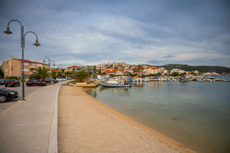 Rogoznica, Croatia - October 12, 2021: Coastline view at marble Rogoznica town scenery with sandy beach in foreground, Mediterranean Croatia.のeditorial素材