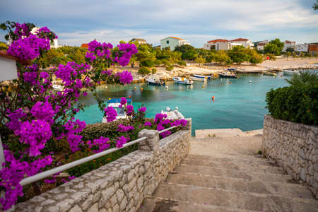 Rogoznica, Croatia - October 12, 2021: Beautiful area Lozica of Rogoznica town with sandy beach, white architecture and fishing boats at sunset time, Croatia.のeditorial素材