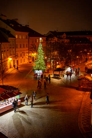 Prague, Czech Republic - December 8, 2021: People on Christmas Market near Charles bridge with vendors and decorationsのeditorial素材