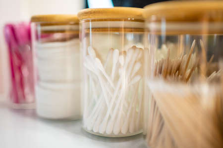 Containers with cotton swabs, tweezers, and brushes for styling eyebrows, accessories for the master...