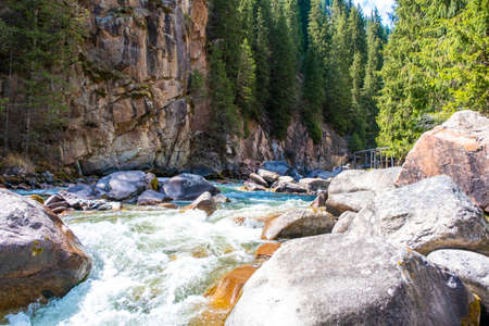 Beautiful mountain river with strong current, foam and water splashes. Beautiful mountain river with...