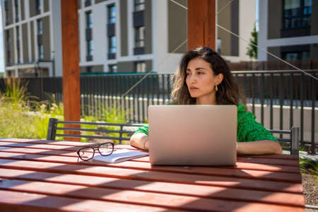 Caucasian woman working with laptop computer outside office.の写真素材