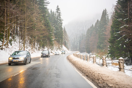 Spindleruv Mlyn, Czech republic - December 20, 2022: Road to Spindleruv Mlyn in winter with lot of snow and snow barriers. Mountain road near Hradec Kralove, Czech republic. High quality photoのeditorial素材