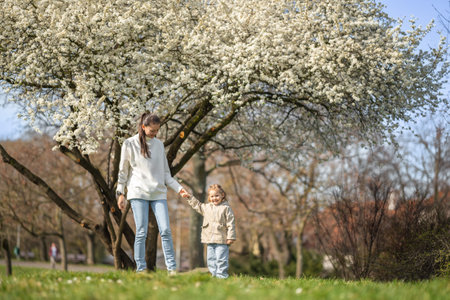 Young mother and her cute daughter having a fun in spring time park in Prague, Europe. High quality photoの写真素材