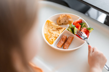 Little girl have a balanced breakfast in home kitchen in the morning. high quality photoの写真素材