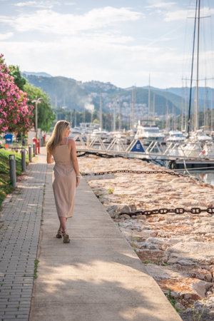 A beautiful fashion caucasian woman on luxury yachts background in marina. High quality photoの写真素材