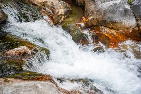 Fast flowing water in Sapadere canyon with rocks and stones in the Taurus mountains near Alanya,...