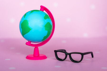 Toy black glasses and globe close-up. Back to school concept. High quality photoの写真素材