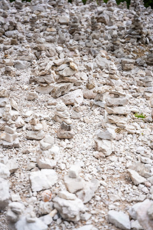 Small stone pyramides near alpine lake Braies or Pragser Wildsee, Dolomites Alps, Italy. High quality photoの写真素材