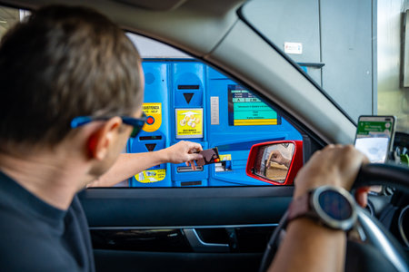 South Tyrol, Italy - August 3, 2023: Man in a car paying by card at an Italian tollbooth for using the highway or Autostrade. High quality photoのeditorial素材