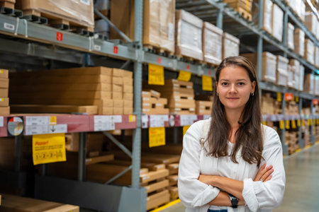 Portrait of woman customer or store worker with shelves in storage as background. High quality photoの写真素材