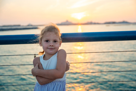 Little girl have a fun on embankment overlooking presidential palace and sunset in Abu Dhabi, UAE. High quality photoの写真素材