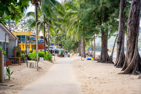 Phuket, Thailand - December 19, 2023: Close up view of a tropical sandy beach with people in Phuket island in the morning. High quality photoのeditorial素材
