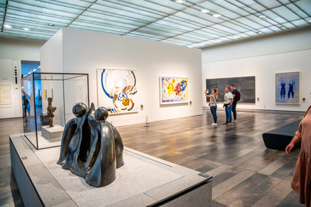 Abu Dhabi, UAE - December 6, 2023: Interior of Louvre and Visitors looking at exhibits, museum in...