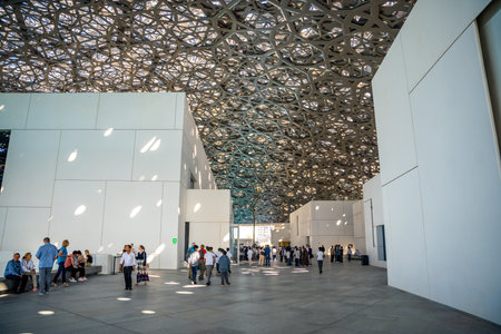 Abu Dhabi, UAE - December 6, 2023: Interior of Louvre and Visitors looking at exhibits, museum in Abu Dhabi, UAE. High quality photoのeditorial素材