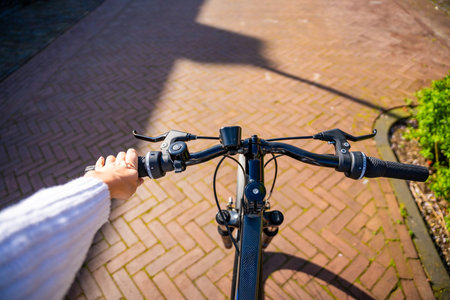 Cyclist woman riding in a sunny summer park, first-person view. High quality photoの写真素材