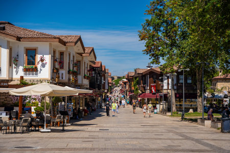 Side, Turkey - May 8, 2024: People on streets of the city centre and the bazaar in Side, Antalya. Street view with cafe, restaurant, shop and houses, Turkey. High quality photoのeditorial素材