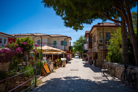 Side, Turkey - May 8, 2024: People on streets of the city centre and the bazaar in Side, Antalya. Street view with cafe, restaurant, shop and houses, Turkey. High quality photoのeditorial素材