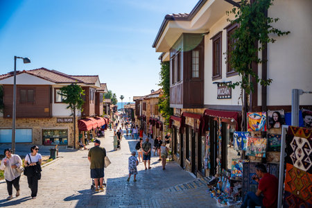 Side, Turkey - May 8, 2024: People on streets of the city centre and the bazaar in Side, Antalya. Street view with cafe, restaurant, shop and houses, Turkey. High quality photoのeditorial素材