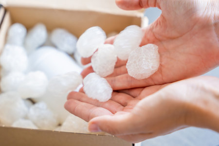 Eco packaging of parcels and white biodegradable filler. Box is filled with a filler safety for...