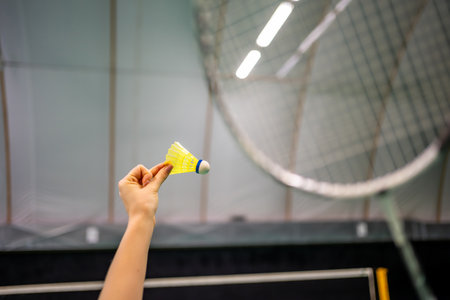 Close up view of racket and shuttlecock, practicing serve before playing in badminton on inside court. High quality photoの写真素材