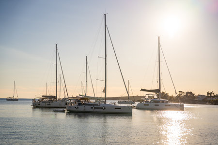 Uvala Gradina, Croatia - July 5, 2024: Yachts moored on buoys near the shore in the bay of Uvala Gradina near the town of Vela Luka on the island of Korcula in Croatia. High quality photoのeditorial素材