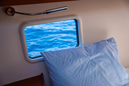 Yacht boat interior. Sailing yacht interior with window and bed. High quality photoの写真素材
