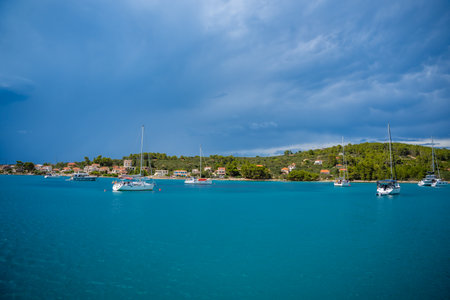Uvala Gradina, Croatia - July 5, 2024: Yachts moored on buoys near the shore in the bay of Uvala...