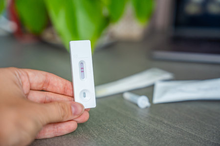 Rapid Antigen Test kit with with Positive result during swab COVID-19 testing. Coronavirus Self...