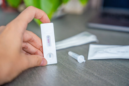 Rapid Antigen Test kit with with Positive result during swab COVID-19 testing. Coronavirus Self nasal or Home test, Autumn exacerbation of viruses. High quality photoの写真素材