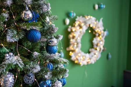 Christmas tree with blue and silver toys. Festively decorated Christmas tree with garlands. Symbol of the new year in trend colors. High quality photoの写真素材
