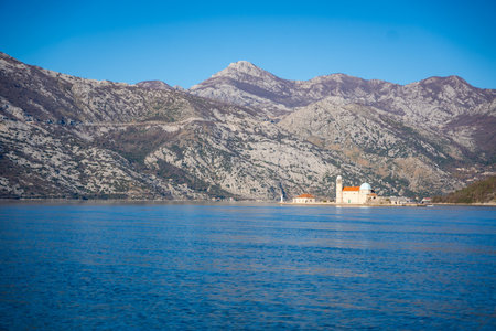 View from yacht boat of Island and Church of Our Lady of the Rocks near Perast in Montenegro. Boka...