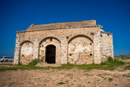 An old Orthodox church in ruins stands by the sea on the northern coast of Cyprus. The image reflects history, faith, and the passage of time in a coastal Mediterranean setting. High quality photoの写真素材