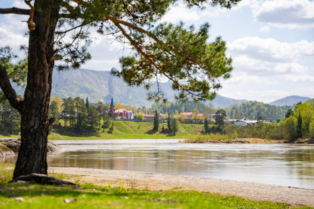 View from the Love Stone over the Biya River with the town of Turochak on the opposite bank. Concept of serenity, connection, and sacred places in wild Russian nature. High quality photoの写真素材